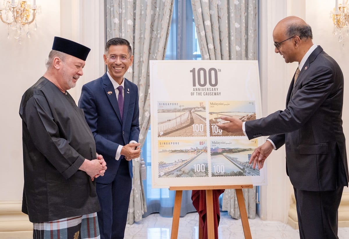 Group of seven people in business attire, standing beneath the "ERBER Group" logo and monitors showing produce.
